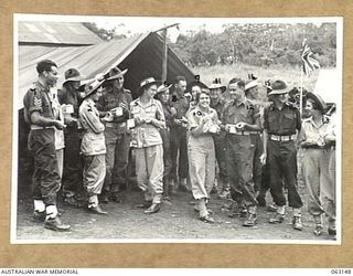 DONADABU, PAPUA, NEW GUINEA. 1944-01-01. ARMY PERSONNEL ENJOYING AN INFORMAL LUNCHEON AT THE 15TH INFANTRY BRIGADE GYMKHANA. WITH THE EXCEPTION OF CORPORAL A. WARR, ALL THE GIRLS ARE FROM THE 2/9TH ..