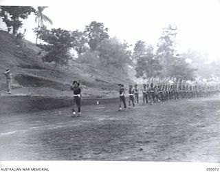 RABAUL, NEW BRITAIN, 1946-04-06. TROOPS OF A COMPANY, 3 NEW GUINEA INFANTRY BATTALION, PACIFIC ISLANDS REGIMENT, PASSING THE SALUTING BASE DURING THE MARCH PAST. THE SALUTE WAS TAKEN BY ..