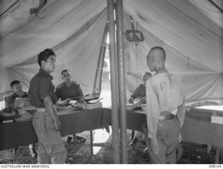 CAPE WOM, NEW GUINEA. 1945-10-19. LIEUTENANT TAZAKI, OF THE JAPANESE ARMY, BEING QUESTIONED AT HEADQUARTERS 6 DIVISION BY THE WEWAK WAR CRIMES COMMISSION, WHICH IS TAKING SUMMARIES OF EVIDENCE FOR ..