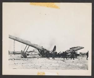 [United States Marines Marching Passed Crashed Japanese Kawanishi H8K on Saipan]