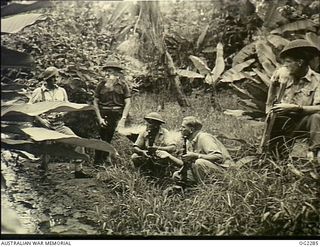 TOROKINA, BOUGAINVILLE ISLAND, SOLOMON ISLANDS. C. 1945-02-23. RAAF GUARDS PAUSE FOR A WELL EARNED SMOKE DURING JUNGLE TRAINING EXERCISES IN THE TOROKINA AREA