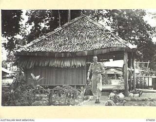 LAE, NEW GUINEA. 1944-07-14. VX43042 COLONEL J.G. HAYDEN, CBE, ED, COMMANDING OFFICER, 2/7TH AUSTRALIAN GENERAL HOSPITAL, WALKING ALONG THE PATH FROM HIS QUARTERS TO THE HOSPITAL