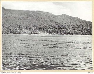 KARKAR ISLAND, NEW GUINEA. 1944-05-18. A GROUP OF JAPANESE HUTS ON THE SHORE LINE, UNDER FIRE DURING A BOMBARDMENT OF THE ISLAND BY HMA MOTOR LAUNCHES. IT IS ANTICIPATED THAT THE ISLAND WILL BE ..