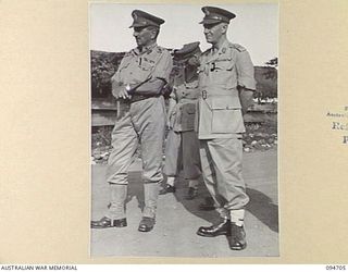 LAE AREA, NEW GUINEA. 1945-08-04. MAJOR GENERAL B.M. MORRIS, GENERAL OFFICER COMMANDING ANGAU (1) AND MAJOR GENERAL V.A.H. STURDEE, GOC FIRST ARMY (2), ATTENDING THE ARTS AND CRAFT EXHIBITION HELD ..