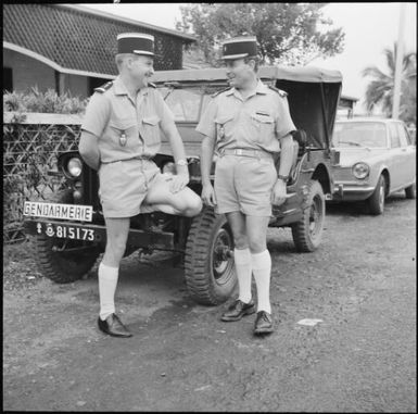 Gendarmes standing in front of a Willys jeep, New Caledonia, 1969 / Michael Terry