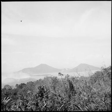 Smoke rising from Vulcan Island after the eruption with Mother and South Daughter Mountains in distance, Rabaul Harbour, New Guinea, 1937 / Sarah Chinnery