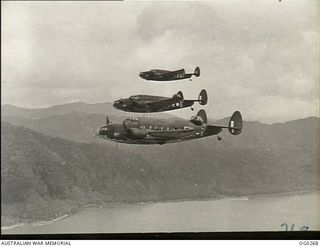 PAPUA. C. 1943-04. THREE LOCKHEED HUDSON BOMBER AIRCRAFT OF NO. 6 SQUADRON RAAF, CODED FX-F, FX-G, FX-E, IN FLIGHT IN THE MILNE BAY AREA