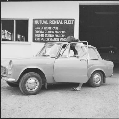 Woman getting into a rental car from Mutual Rental Fleet, Fiji, 1966, 3 / Michael Terry