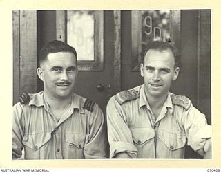 PORT MORESBY, PAPUA, NEW GUINEA, 1944-02-14. CAPTAIN ROBIN WOOD (2) THE STATION SUPERVISOR AT THE AUSTRALIAN BROADCASTING COMMISSION'S 9PA BROADCASTING STATION, WITH MR. VAL ANDERSON (1) A WAR ..