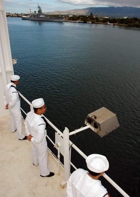 US Navy (USN) Sailors man the rails aboard the USN Military Sealift Command (MSC), Hospital Ship, USNS MERCY (T-AH 19) as the ship departs the harbor following its port visit at Navy Base Pearl Harbor, Hawaii (HI). The USNS MERCY is starting a scheduled five-month deployment to deliver aid and humanitarian assistance to the Pacific Islands, and Southeast Asia