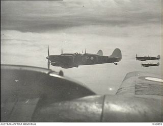 BISMARCK ARCHIPELAGO. 1944-03-28. AIRCRAFT, CODE NAMED UP-T, UP-S, UP-C AND UP-W, OF NO. 79 (SPITFIRE) SQUADRON RAAF, IN FLIGHT OVER NEW BRITAIN EN ROUTE FROM KIRIWINA TO THE ADMIRALTY ISLANDS. ..