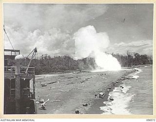 MALAHANG BEACH, LAE, NEW GUINEA. 1945-10-16. TROOPS OF FIRST ARMY DESTROYED SURPLUS AMMUNITION ON MALAHANG BEACH. SHOWN, CORDITE BURNING FIERCELY. DRUMS LITTERING THE BEACH ARE SOME OF THOSE WASHED ..