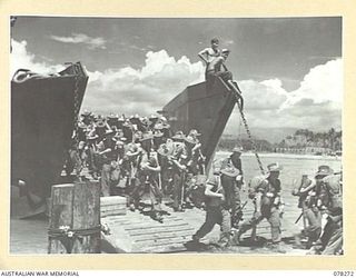 TOROKINA, BOUGAINVILLE ISLAND. 1945-01-02. TROOPS OF THE 24TH INFANTRY BATTALION, DISEMBARKING FROM AN LANDING CRAFT TROOPS DURING THE UNIT MOVE TO THE JABA RIVER AREA