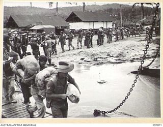 BORAM BEACH, NEW GUINEA. 1945-10-13. THE FIRST BATCH OF TROOPS TO LEAVE THE WEWAK AREA UNDER THE PRIORITY DEMOBILISATION SCHEME WERE MEMBERS OF 6 DIVISION. SHOWN, THE TROOPS LEAVING THE BEACH AND ..