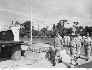 LAE, NEW GUINEA. 1944-11-05. NX369 CHAPLAIN P.T. BOLAND, ASSISTANT CHAPLAIN GENERAL, (ROMAN CATHOLIC) WITH VX135323 PRIVATE G.G. MEREDITH, HEADQUARTERS, 1ST AUSTRALIAN ARMY AND NX70612 CHAPLAIN ..