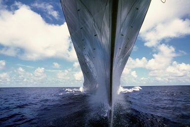 A water-level bow view of the battleship USS MISSOURI (BB-63) underway. The ship is en route to Hawaii prior to a cruise to Australia and around the world