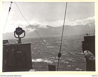 AT SEA OFF RABAUL, NEW BRITAIN. 1945-09-04. THE MOUNTAINOUS COASTLINE OF NEW IRELAND VIEWED FROM THE BRIDGE OF HMAS VENDETTA AS THE SHIP PROCEEDS TO A SEA RENDEZVOUS WITH REPRESENTATIVES OF GENERAL ..