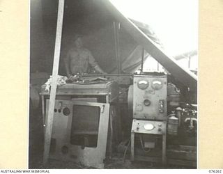 LAE, NEW GUINEA. 1944-09-27. AN ELECTRICIAN WORKING IN HIS TENT WORKSHOP AT THE 43RD FIELD ORDNANCE DEPOT