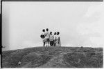 Pete Vayda with men at top of hill