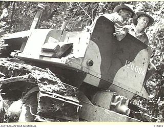 1943-09-25. NEW GUINEA. FALL OF LAE. ARTILLERY PLAYED A BIG PART IN THE FALL OF LAE. DURING THE ADVANCE ARTILLERY WAS HAULED THROUGH JUNGLES AND OVER STREAMS. A BULLDOZER CLEARS A PATH THROUGH THE ..