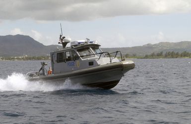 A US Navy (USN) Naval Base (NB) Guam Security Force Harbor Patrol Police 28-foot Dauntless Sea-Ark high-speed patrol boat is underway through NB Guam, Apra Harbor, Guam (GU), conducting harbor security patrols