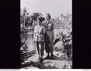 BUSU RIVER, NEW GUINEA. C. 1944. PHYSIOTHERAPISTS LIEUTENANT (LT) J. DICKSON AND LT RUTH MCCARTHY, AUSTRALIAN ARMY NURSING SERVICE, ON THE BANK OF THE BUSU RIVER NEAR LAE. (DONOR E. FUSSELL)