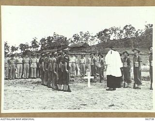 BOMANA WAR CEMETERY, PAPUA, NEW GUINEA. 1943-12-29. CHAPLAIN J. D. MCKIE, CHURCH OF ENGLAND, CONDUCTING A GRAVESIDE MEMORIAL SERVICE FOR PENDIL A. RAYNER, AN AUSTRALIAN WAR CORRESPONDENT, WHO WAS ..