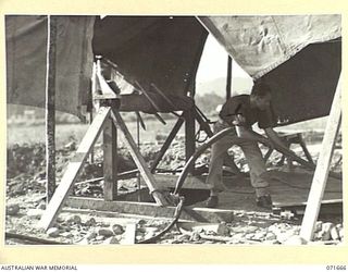 LAE, NEW GUINEA. 1944-03-24. A WELL CONSTRUCTED BY THE 2/7TH ADVANCED WORKSHOPS, AUSTRALIAN ELECTRICAL AND MECHANICAL ENGINEERS TO TAP A RUNNING STREAM 31 FEET UNDERGROUND LOCATED BY A WATER ..