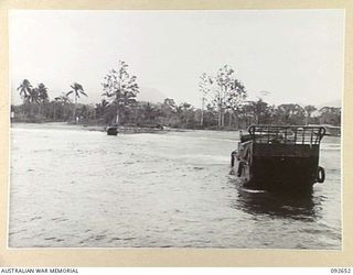 PURUATA ISLAND, SOUTH BOUGAINVILLE. 1945-05-29. LANDING CRAFT MECHANIZED OF 42 LANDING CRAFT COMPANY BACKING IN THROUGH SURF TO THROW A LINE ASHORE IN AN ATTEMPT TO TOW A BARGE OFF NO. 1 BEACH ..
