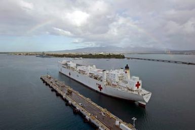 The U.S. Navy Military Sealift Command Hospital Ship, the USNS MERCY (T-AH 19) enters Pearl Harbor, HI., for a brief port visit before returning to her homeport in San Diego, Calif. The USNS MERCY (T-AH 19) which operated off the coast of Dili, East Timor provided humanitarian assistance to local residents. Sept. 20, 2006. (U.S. Navy photo by CHIEF Mass Communication SPECIALIST 1ST Class Dennis Cantrell) (Released)