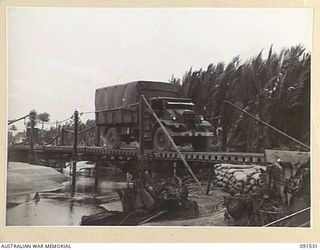 BOUGAINVILLE. 1945-05-02. A 3 TONNER CROSSING THE TRESSLE APPROACHES TO THE FLOATING BOAT EQUIPMENT BRIDGE OVER THE LAGOON ON THE MOTUPENA POINT - TOKO ROAD, CONSTRUCTED BY 5 FIELD COMPANY, ROYAL ..