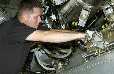 US Air Force (USAF) STAFF Sergeant (SSGT) Clayton Carver, Weapons Loader, assigned to the 2nd Bomb Wing (BW), installs a Conventional Air Launch Cruise Missile into the weapons bay of a USAF B-52H Stratofortress aircraft while deployed with the 7th Air Expeditionary Wing (AEW) at Andersen Air Force Base (AFB), Guam, during Operation ENDURING FREEDOM