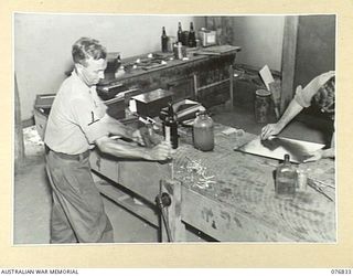 LAE, NEW GUINEA. 1944-11-11. A CONVALESCENT PATIENT AND AN INSTRUCTOR WORKING IN THE HOBBIES HUT AT THE 112TH CONVALESCENT DEPOT