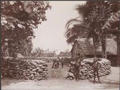 Children at the dancing ground and gamal in the village of Pileni, Reef Islands, 1906 / J.W. Beattie