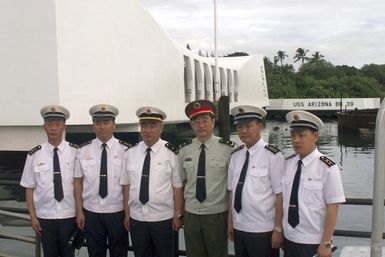 Chinese People's Liberation Army (Navy) Officers pose for a photograph in front of the USS ARIZONA (BB 39) Memorial, at Pearl Harbor, Hawaii