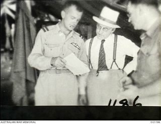 AITAPE, NORTH EAST NEW GUINEA. C. 1944-06. AT HEADQUARTERS NO. 10 GROUP RAAF, LEFT TO RIGHT: AIR COMMODORE F. R. W. SCHERGER, THE AIR OFFICER COMMANDING NO. 10 GROUP RAAF, ARTHUR DRAKEFORD, THE ..