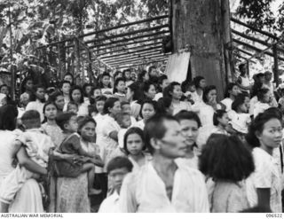 RABAUL AREA, NEW BRITAIN. 1945-09-13. CHINESE CIVILIANS, INTERNED BY THE JAPANESE AT A CAMP 15 MILES WEST OF RABAUL, WERE CONTACTED BY A PARTY OF AUSTRALIAN ARMY AND RED CROSS OFFICIALS SOON AFTER ..