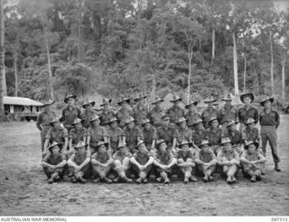 Group portrait of members of 3 Platoon, Headquarters Company, 58/59 Infantry Battalion. Identified, back row, left to right: Private (Pte) M Kelly; Pte R Arrow; Pte E Greenham; Pte A Valentine; Pte ..
