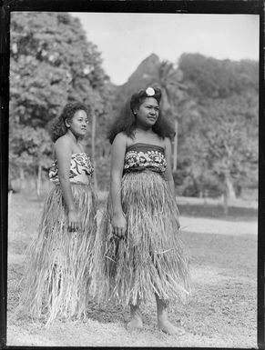 Two unidentified local women wearing number 1 laplaps and hula skirts, Rarotonga, Cook Islands