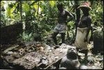 Men with skull shrine and man figured stone sculpture