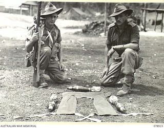 WUNUNG PLANTATION, JACQUINOT BAY, NEW BRITAIN. 1945-02-01. THE LAY- OUT OF THE NEW MORTAR BOMB CARRIER DEVISED BY WX29776 SERGEANT R. MCCAUGHAN, 16TH INFANTRY BATTALION (1), ALSO SEEN IS WX32978 ..