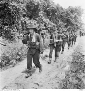 MADANG AREA, NEW GUINEA. 1944-04-26. TROOPS OF D COMPANY, 35TH INFANTRY BATTALION, MOVING ALONG THE MADANG - ALEXISHAFEN ROAD. IDENTIFIED PERSONNEL ARE:- NX120687 PRIVATE A.J. TURNER (1); NX120500 ..