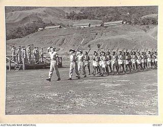 NADZAB AREA, NEW GUINEA, 1945-06-27. THE MARCH PAST OF B COMPANY, DEPOT BATTALION, PACIFIC ISLANDS REGIMENT, LED BY LT D.S. VANDERFIELD, COMPANY COMMANDER (1). THE SALUTE WAS TAKEN BY HIS ROYAL ..