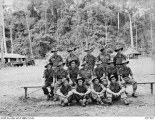 Group portrait of members of 15 Platoon, C Company, 58/59 Infantry Battalion. Identified, back row, left to right: Private (Pte) A Sharp; Corporal (Cpl) M Bryant; Pte A Meek; Pte A Tindall; Lance ..