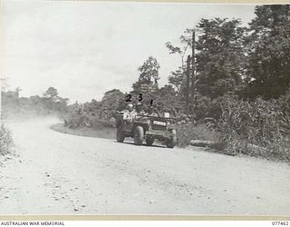 LAE BASE AREA, NEW GUINEA. 1944-12-04. A JEEP BEING ROAD TESTED AFTER BEING OVERHAULED IN THE WORKSHOPS OF THE 2/77TH LIGHT AID DETACHMENT. IDENTIFIED PERSONNEL ARE:- NX25340 SERGEANT L.C. POOLE ..