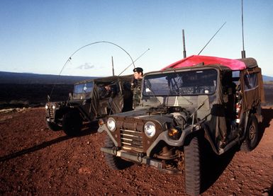 A forward air controller, using a radio, directs an F-4 Phantom II aircraft a bomb target. The controller is from the 22nd Tactical Air Support Squadron and is involved in Exercise Opportune Journey 4