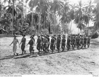 SIAR, NEW GUINEA. 1944-06-23. PERSONNEL OF BATTALION HEADQUARTERS, 57/60TH INFANTRY BATTALION MARCHING OFF THE UNIT PARADE GROUND AT THE CONCLUSION OF THE MORNING PARADE. IDENTIFIED PERSONNEL ARE:- ..
