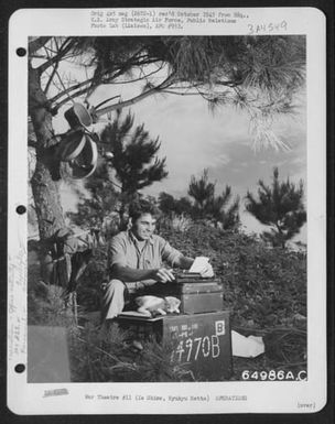 'Rum And Coke', A Feline Veteran Of Saipan, And One Of The Mascots Of The 364Th Air Service Group, Proves A Playful Paper Weight As 1St Sgt. John Pavesick Of Mcdonald, Ohio, Types His Morning Report At An Improvised Desk In The Shade Of A Tree On Ie Shima (U.S. Air Force Number 64986AC)