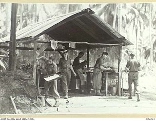 SIAR, NEW GUINEA. 1944-06-20. MEMBERS OF THE KITCHEN STAFF OF A COMPANY, 58/59TH INFANTRY BATTALION, WORKING IN THE UNIT KITCHEN. IDENTIFIED PERSONNEL ARE:- V48797 PRIVATE C. DEMETRI (1); N350155 ..