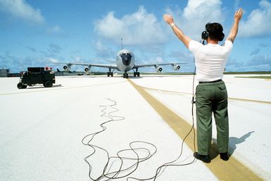 A ground crewman marshals a KC-135 Stratotanker aircraft into a parking position. The aircraft, assigned to the 28th Bomb Wing, is participating in Exercise Glad Customer '82